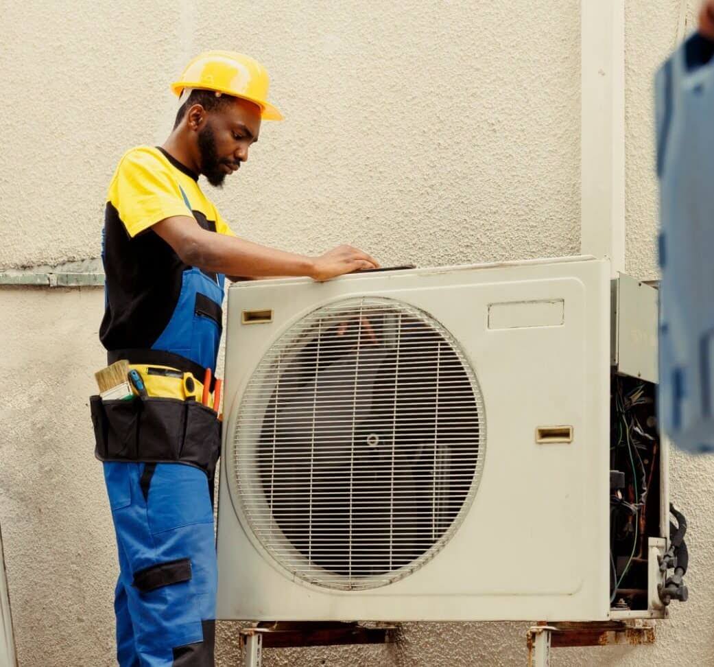 Skilled Tracys Landing HVAC technician investigating ductless mini-split issue.