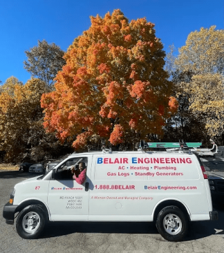A Belair service van parked beneath a tree in fall color near Owings