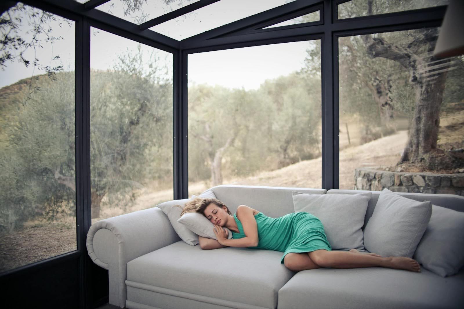 Woman napping on sofa - Belair offers indoor air quality services in Riva